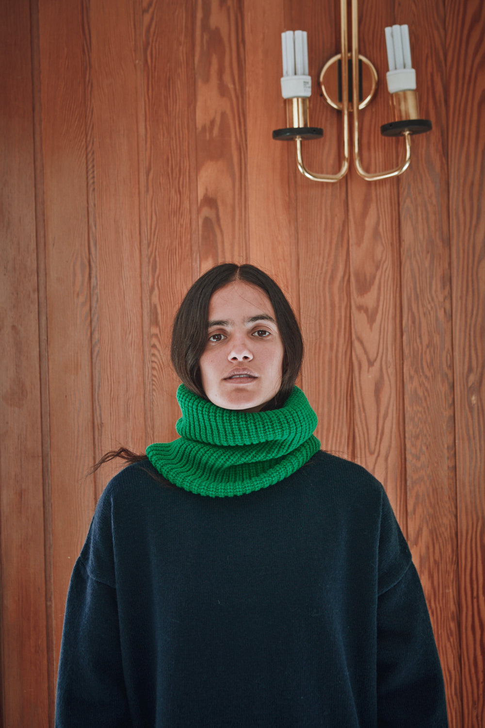 woman wearing the AMANDINE L'ENVERS Parrot Green with a blue pullover